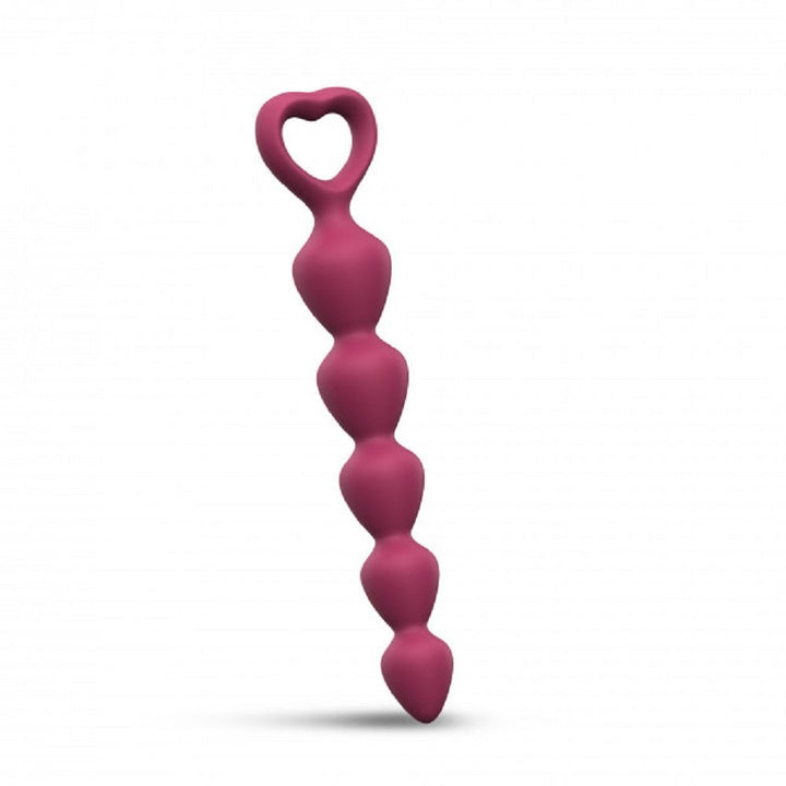 Medium-sized prune silicone anal plug with graduated beads and heart-shaped handle for easy grip.