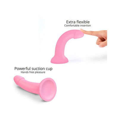 Pink flexible silicone dildo with suction cup base, shown bending under finger pressure for comfortable insertion.