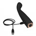 Black ergonomic silicone vibrator with curved head, USB charging cable connected, and power button on base.