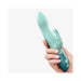 Hand holding a mint green Hello Rabbit vibrator with dual motors and flexible clitoral stimulator ears.