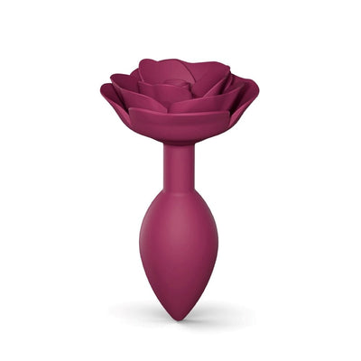 Medium plum-colored silicone anal plug with an open rose design on the base for elegant style and comfort.