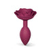 Medium plum-colored silicone anal plug with an open rose design on the base for elegant style and comfort.