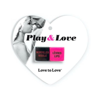 Heart-shaped packaging of Love To Love Play & Love Dice featuring a close couple and two colorful dice with playful actions.