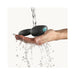 Black ergonomic silicone prostate massager with remote control held under running water to show waterproof feature.