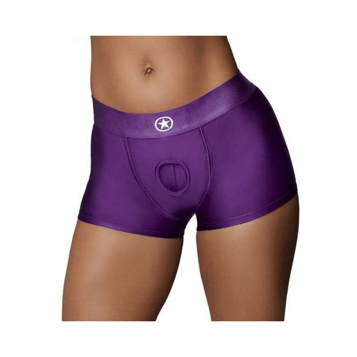 Close-up of a person wearing purple satin boxer briefs with a circular cutout detail on the front waistband.