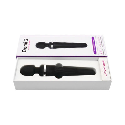 Lovense Domi 2 black wand vibrator in white box with product image and branding on lid.