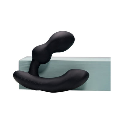Black Lovense Edge 2 flexible prostate massager with curved design resting on a light blue block.