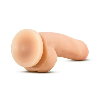 Beige realistic dildo with suction base lying on white background, designed for hands-free use.