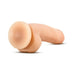 Beige realistic dildo with suction base lying on white background, designed for hands-free use.