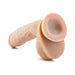 Beige realistic suction cup dildo with detailed texture and attached balls on white background.