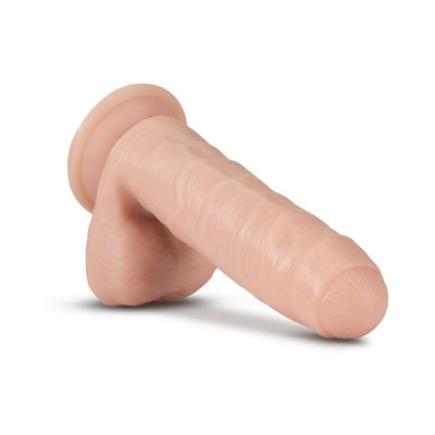 Realistic vanilla-colored silicone dildo with suction cup base and textured surface for hands-free use.