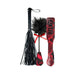 Lovers Kits set with black faux leather whip, red snake print paddle, and feather tickler with red bow on white background.