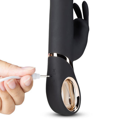 Black Blush Lush Victoria rabbit vibrator with gold accent being plugged in for USB charging.