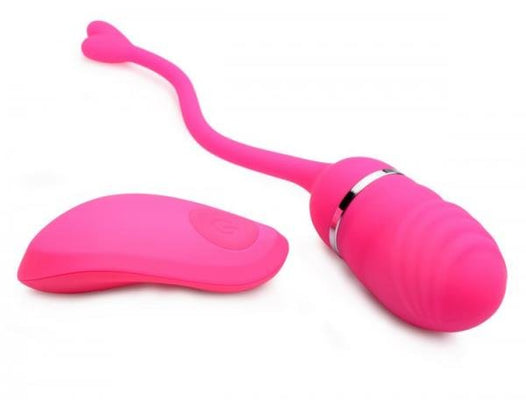 Pink rechargeable remote control egg vibrator with textured silicone surface and flexible retrieval cord.