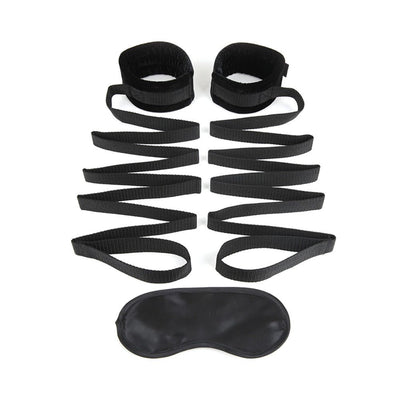 Black adjustable bed strap with soft cuffs and matching blindfold for comfortable restraint play.