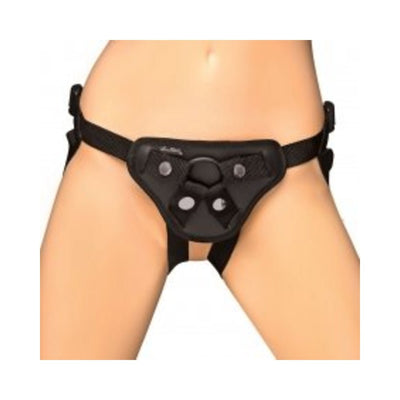 Black adjustable strap-on harness worn around hips and thighs, designed for comfort and secure fit.