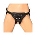 Black adjustable strap-on harness worn around hips and thighs, designed for comfort and secure fit.