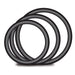 Set of four black silicone O-rings in varying sizes for strap-on harness compatibility and secure fit.