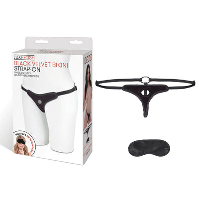 Black velvet bikini strap-on harness with adjustable straps and included black satin blindfold shown with packaging box.