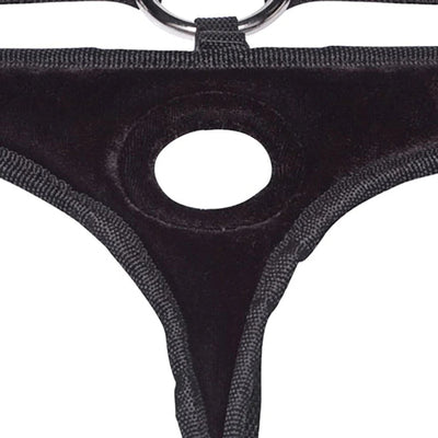 Close-up of black velvet bikini strap-on harness with central ring and adjustable straps