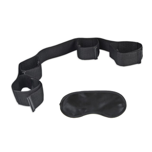 Black adjustable bondage restraint with four cuffs and a matching black blindfold on white background.