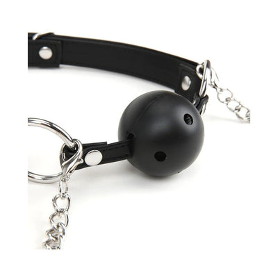 Black breathable ball gag with adjustable leather straps and attached silver nipple clamps with chains.