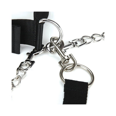 Close-up of black adjustable collar and cuff with silver metal D-rings, chain, and quick-release clips on white background.