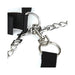 Close-up of black adjustable collar and cuff with silver metal D-rings, chain, and quick-release clips on white background.