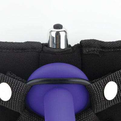 Close-up of black neoprene strap on harness with purple dildo and silver bullet vibrator pocket detail