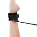 Close-up of a black adjustable ankle strap from the Lux Fetish Position Pal sex sling on a raised leg.