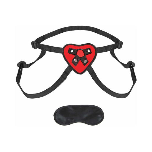 Red heart-shaped strap on harness with black adjustable straps and a black blindfold accessory.