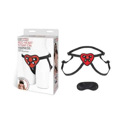 Red heart-shaped adjustable strap on harness with black straps and included black satin blindfold.