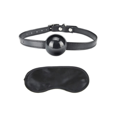 Black silicone ball gag with adjustable strap and matching black satin blindfold set on white background