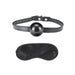 Black silicone ball gag with adjustable strap and matching black satin blindfold set on white background