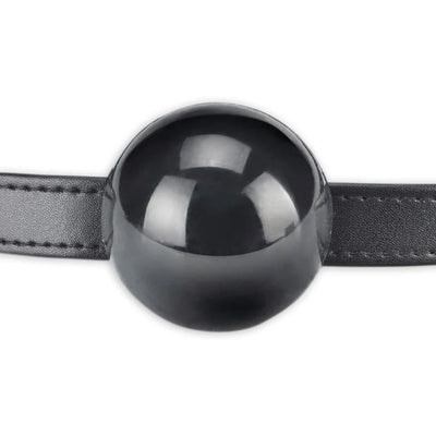 Black silicone ball gag with adjustable leather strap, designed for secure and comfortable fit during intimate play.