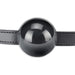 Black silicone ball gag with adjustable leather strap, designed for secure and comfortable fit during intimate play.