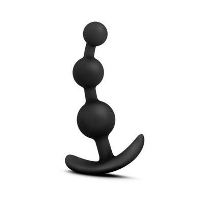 Black silicone anal beads with three graduated spheres and a curved ergonomic base for comfort and control.