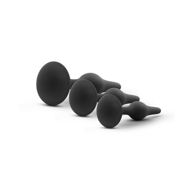 Set of three black silicone beginner butt plugs in graduated sizes with tapered tips and flared bases.
