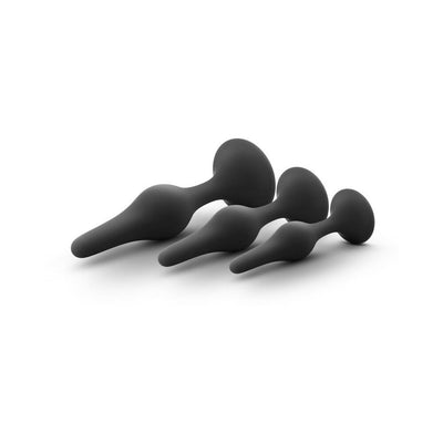 Three black silicone beginner butt plugs in graduated sizes with tapered tips and flared bases on white background
