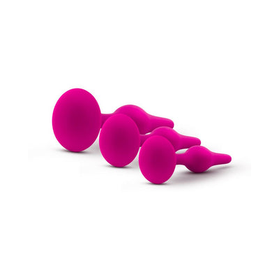 Set of three graduated pink silicone beginner plugs with tapered tips and flared bases on white background.