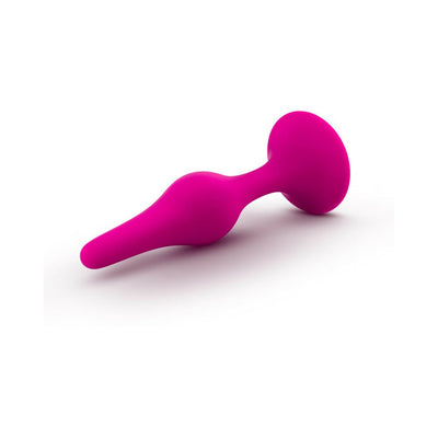 Medium-sized pink silicone beginner plug with tapered tip and flared base for safe, comfortable use.