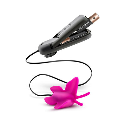 Pink butterfly-shaped clitoral vibrator with black wired remote control and AA batteries shown separately.
