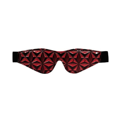 Burgundy luxury eye mask with a textured diamond pattern and black elastic strap for a comfortable fit.