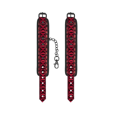 Pair of adjustable burgundy hand cuffs with black padded backing and a black chain with lobster clasp connector
