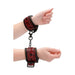Burgundy luxury hand cuffs with black chain and lobster clasp, featuring a diamond pattern and adjustable fit on wrists.