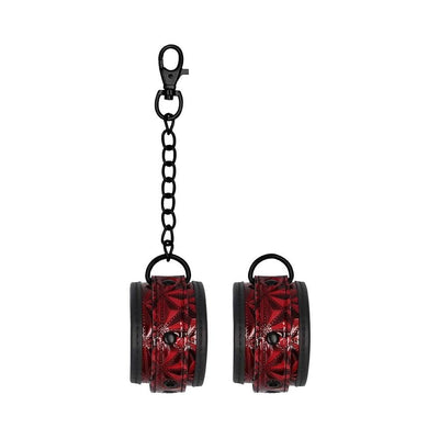 Burgundy luxury hand cuffs with black chain and lobster clasp, featuring adjustable diamond-patterned neoprene and faux leather straps.