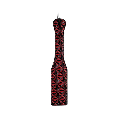 Black and red luxury paddle with a textured diamond pattern and wrist strap detail.