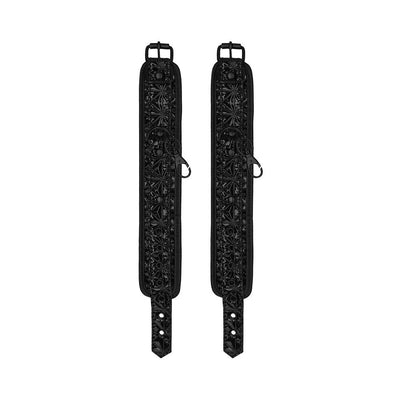 Black neoprene and patent vinyl ankle cuffs with adjustable buckles and decorative diamond pattern.