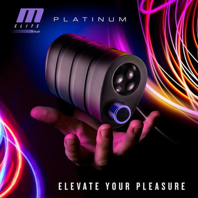 Hand holding the black Blush M Elite Platinum Strok with textured body and power button, colorful light trails in background.