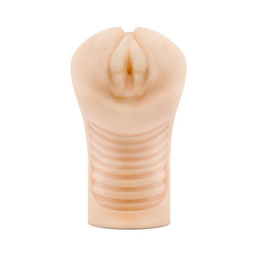 Beige soft textured male pleasure sleeve with ribbed interior and realistic design.
